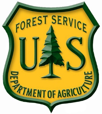 Logo of a badge with a pine tree in the center of the letters U and S, and the words Forest Service, Department of Agriculture