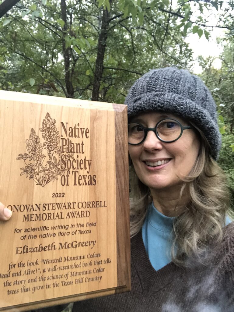 Woman poses with plaque